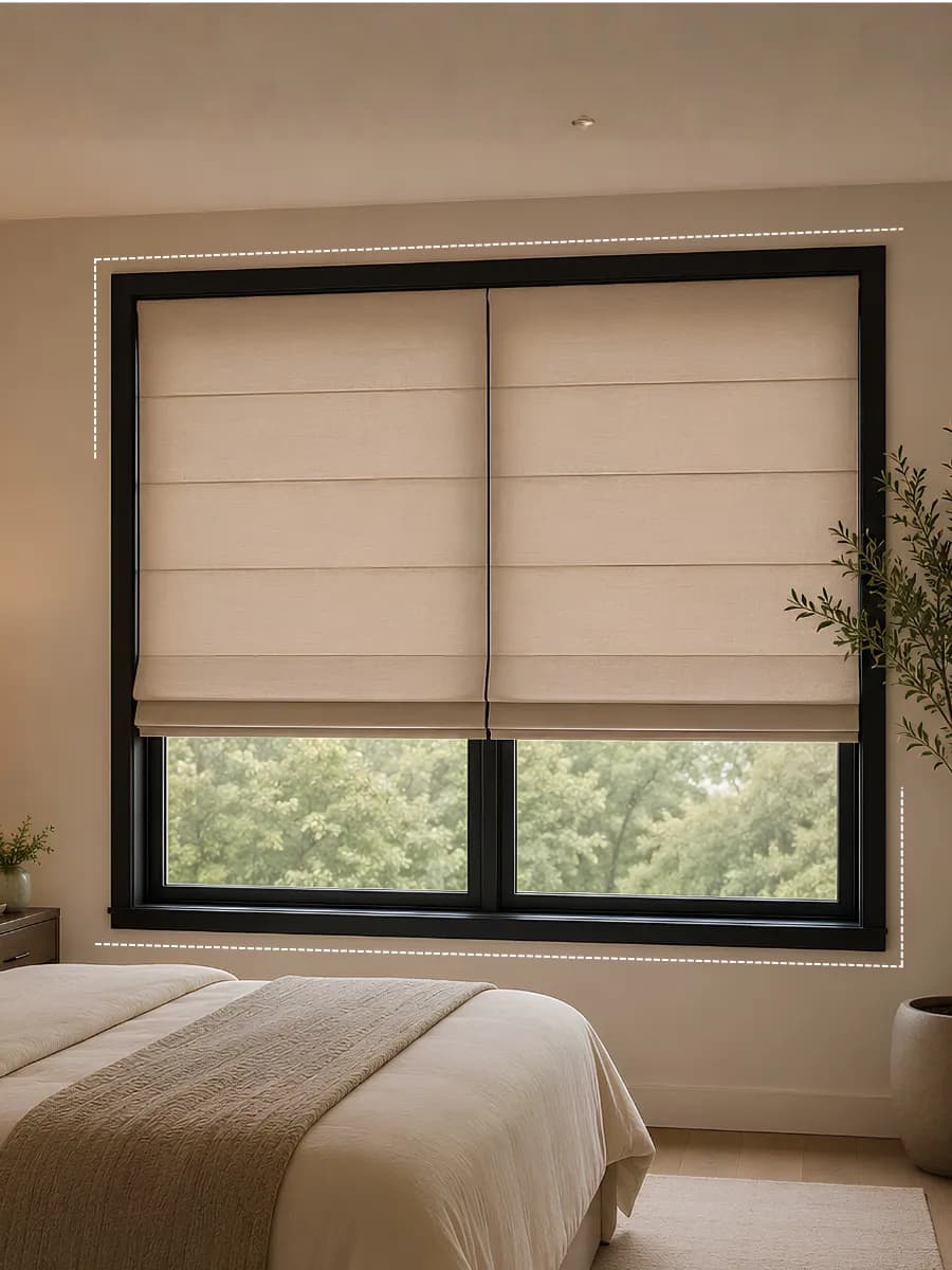 Roman shade on a bedroom window above a neatly made bed